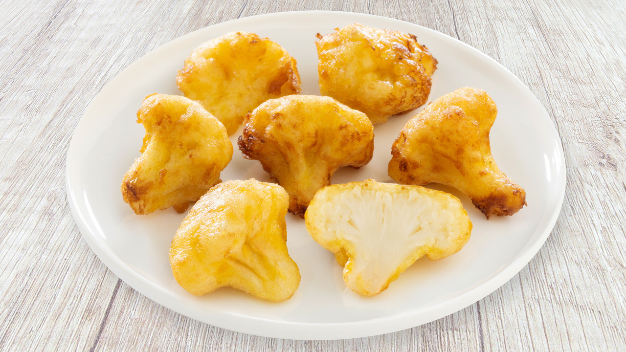 Frozen onion rings and battered vegetables Image